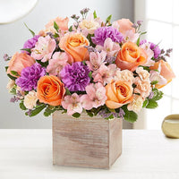 alstroemerias and peach roses with lavender carnations