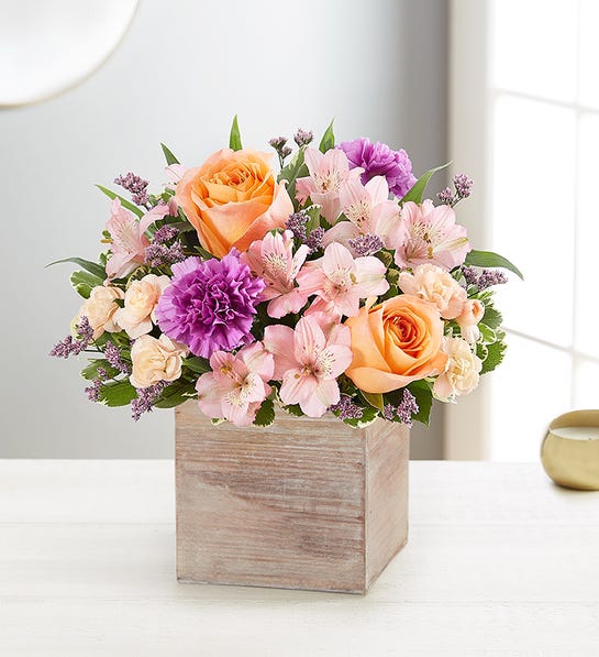 alstroemerias and peach roses with lavender carnations