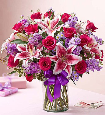Hot pink roses with stargazers, purple stock and purple fillers Same day flowers delivery by local florist near Livermore, Pleasanton, Dublin