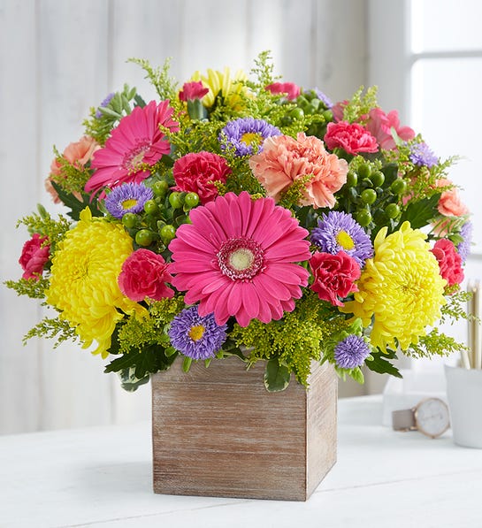 Pink gerbera daisies, yellow footbal mums , orange carnations